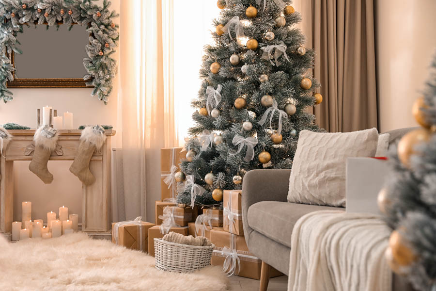 A living room decorated with festive silver, gold, and beige.