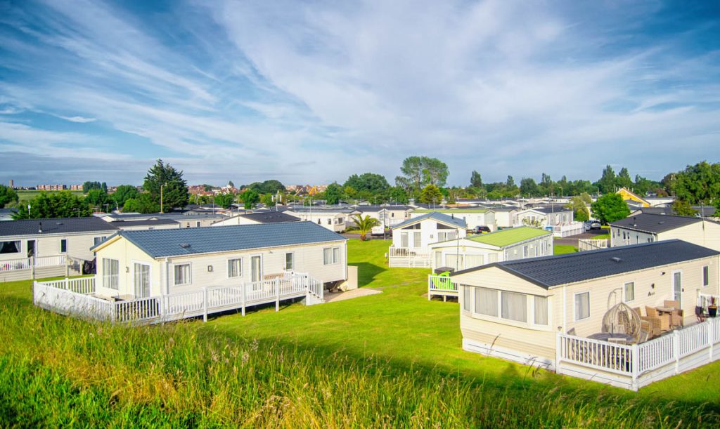 mobile homes on green grass under blue skies