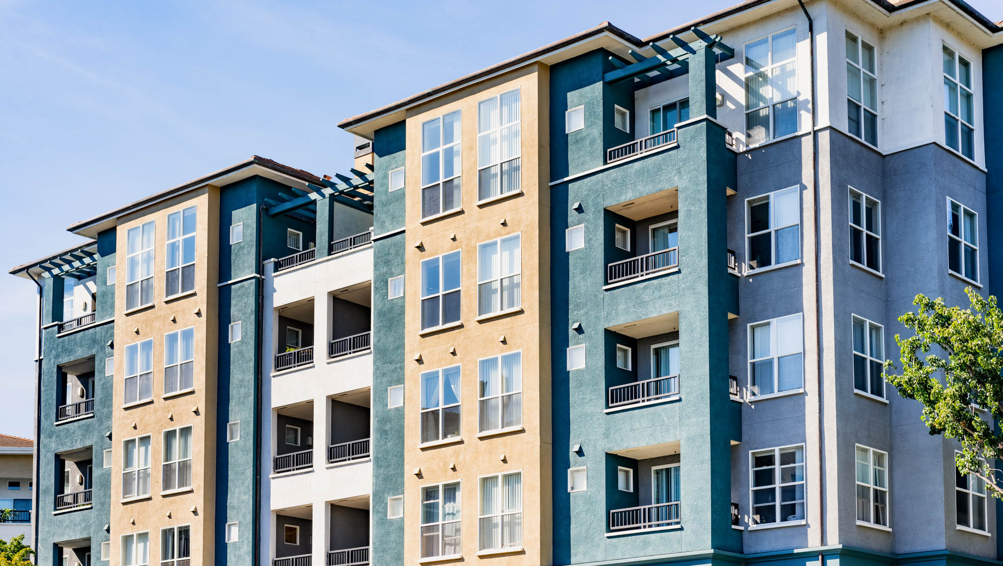 A blue, green and yellow condominium complex