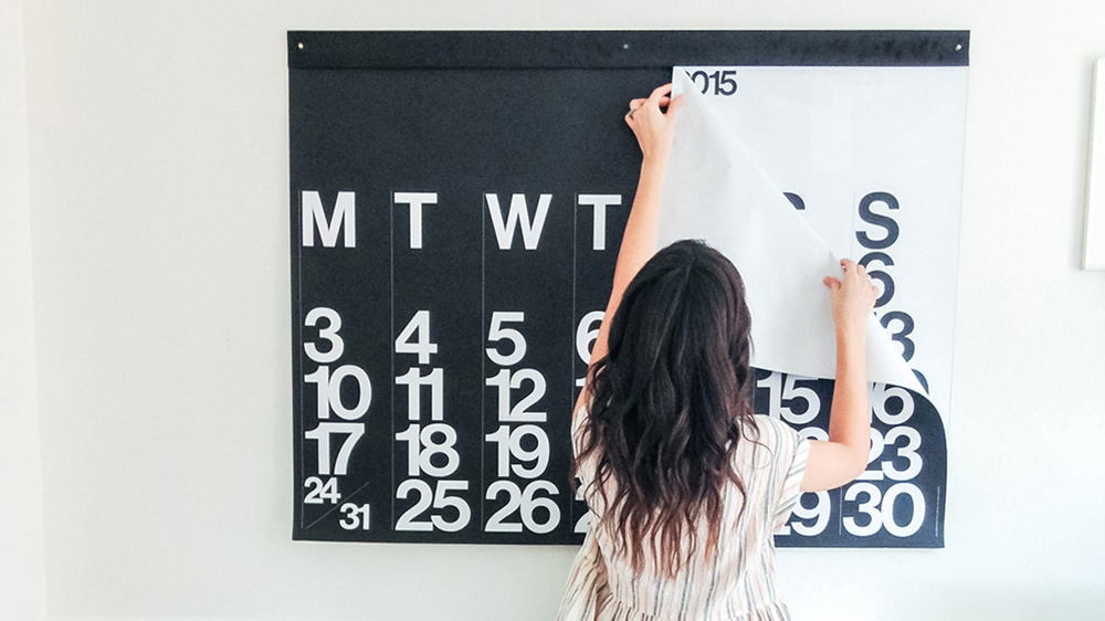 woman ripping off calendar