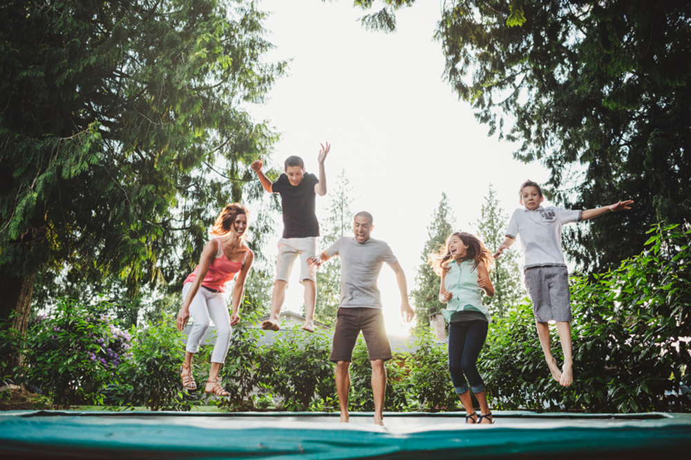 family jumping on a trampoline