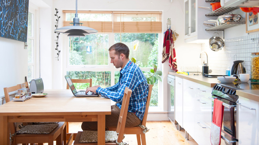 man on computer researching kitchen remodeling plans
