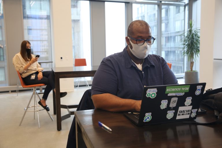 Zillow employee works on a laptop in the office
