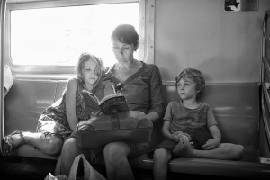 Mom reading to kids on NYC subway
