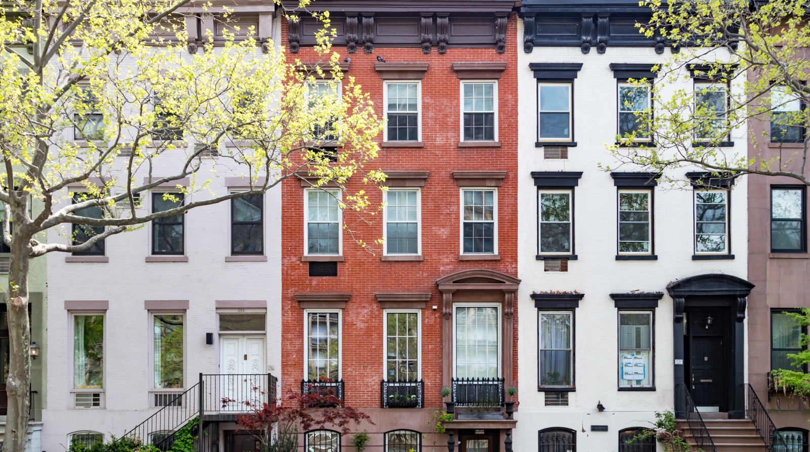 types of townhouses in NYC a row of brick townhouses