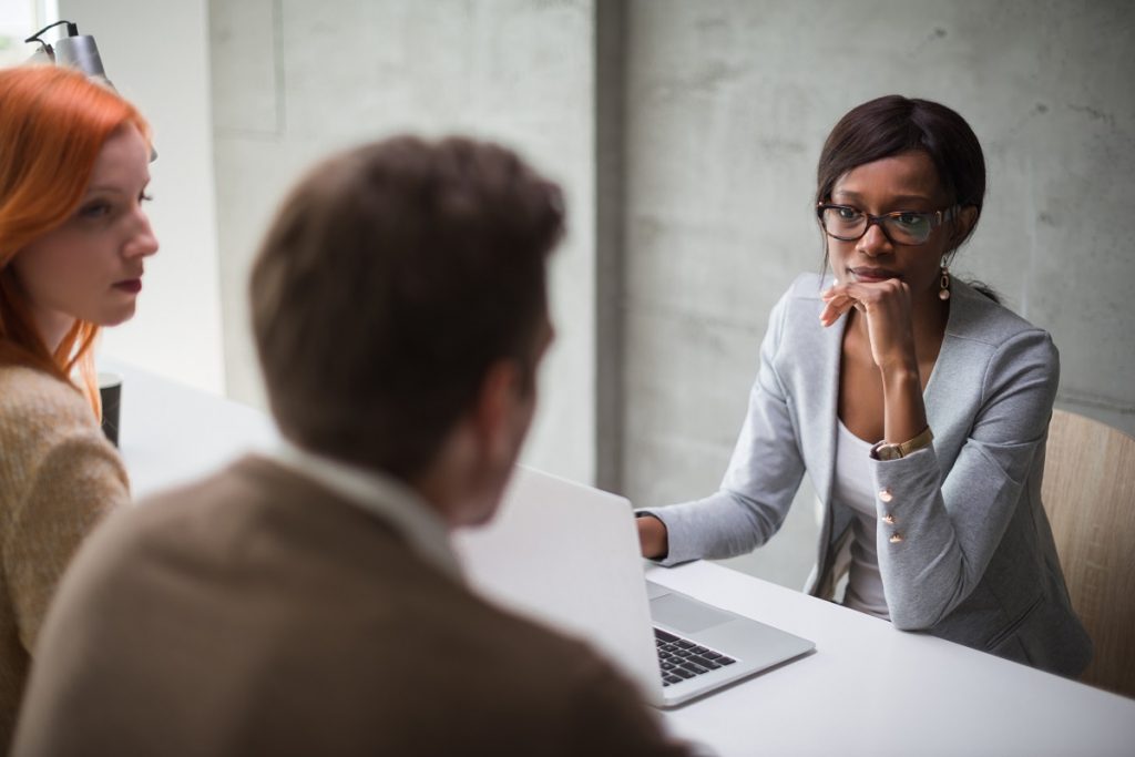 Couple sitting in a meeting with their financial advisor.