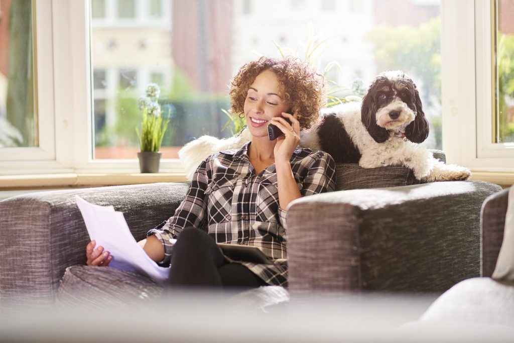 woman on the phone with her loan officer getting a mortgage