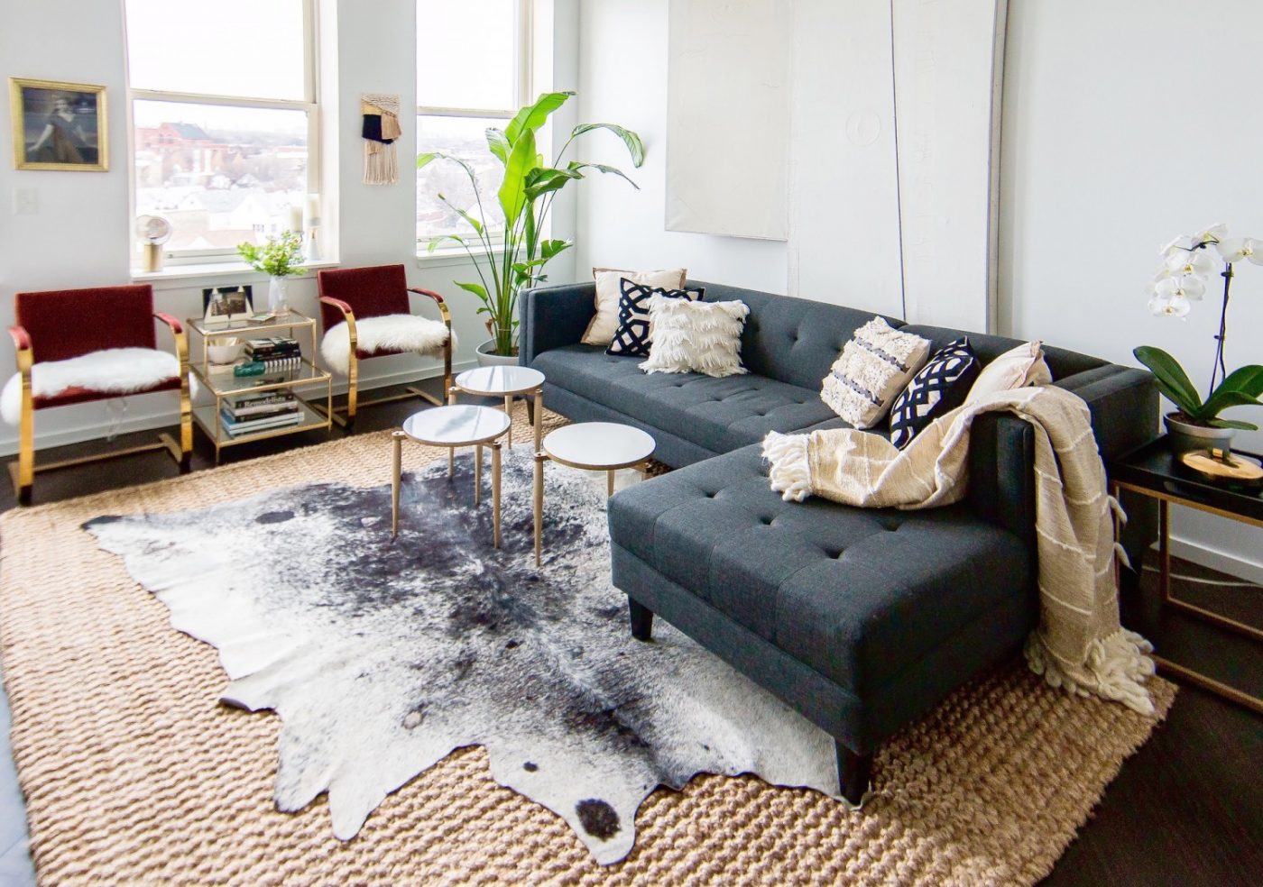 Jute Rug Layered With Cowhide Living Room