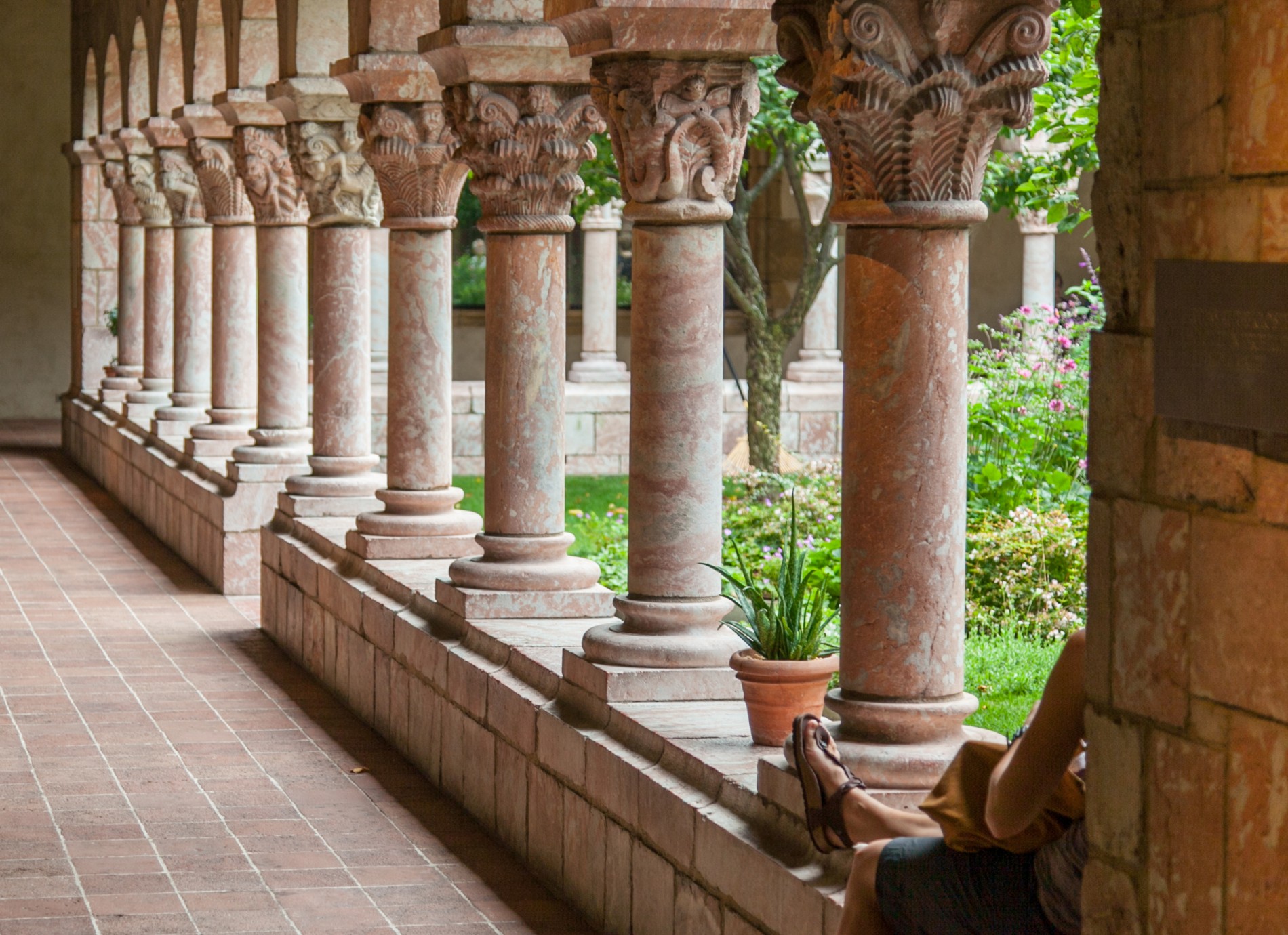 A-visitor-enjoys-a-courtyard-in-the-Cloisters-Museum-NYC-Inwood-708710